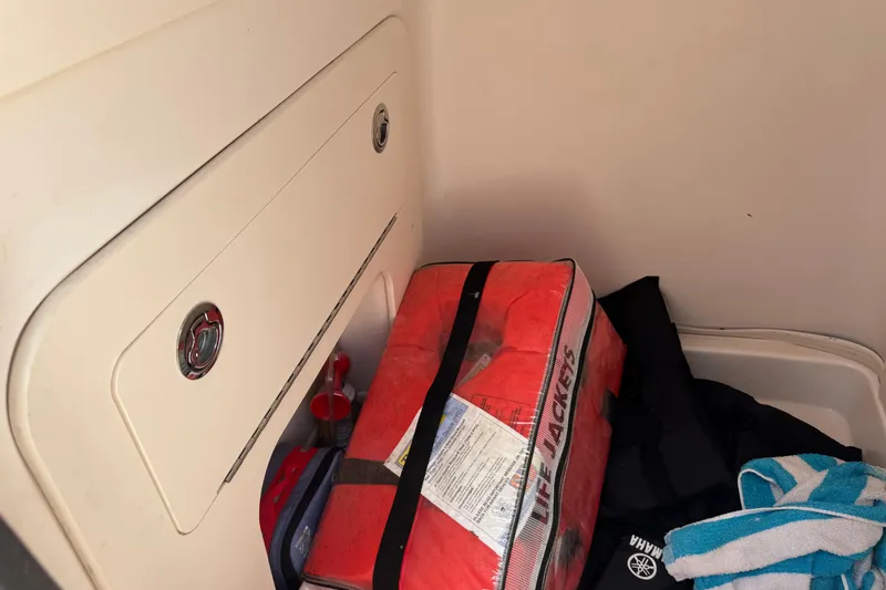 Slide: The Image of Storage compartment on 2021 Grady-White 251 Coastal Explorer with life jackets and gear. - 67