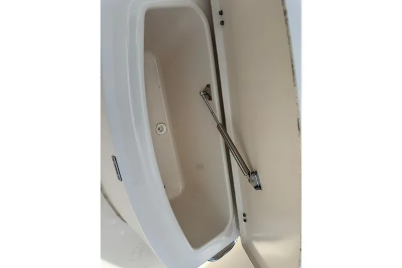 Slide: The Image of Storage compartment of 2021 Grady-White 251 Coastal Explorer boat, featuring hydraulic support. - 79