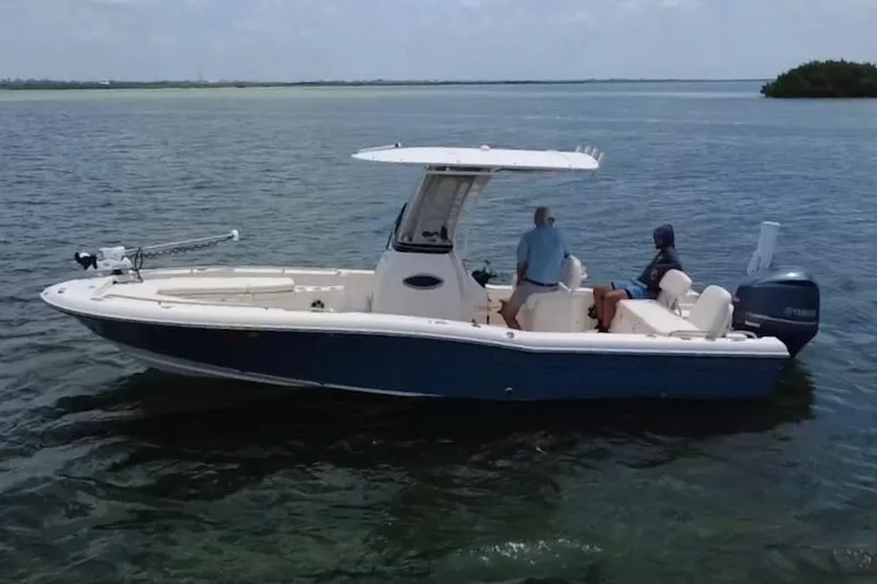Slide: The Image of 2021 Grady-White 251 Coastal Explorer boat on calm water, featuring a sleek design. - 30