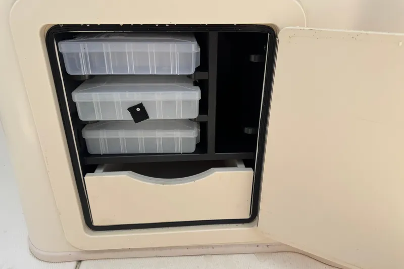 Slide: The Image of Storage compartment with tackle boxes on a 2021 Grady-White 251 Coastal Explorer boat. - 54
