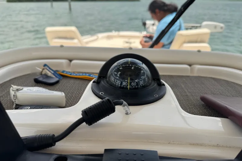Slide: The Image of Compass on 2021 Grady-White 251 Coastal Explorer boat, with person in background. - 65