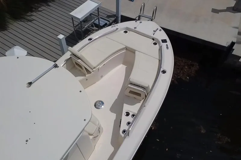 Slide: The Image of 2021 Grady-White 251 Coastal Explorer boat docked, featuring spacious seating and sleek design. - 14