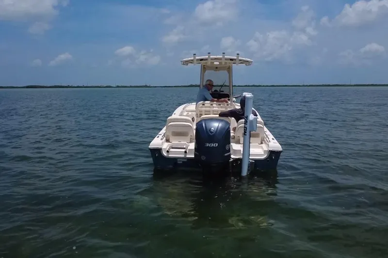 Slide: The Image of 2021 Grady-White 251 Coastal Explorer boat on calm water under blue sky. - 28