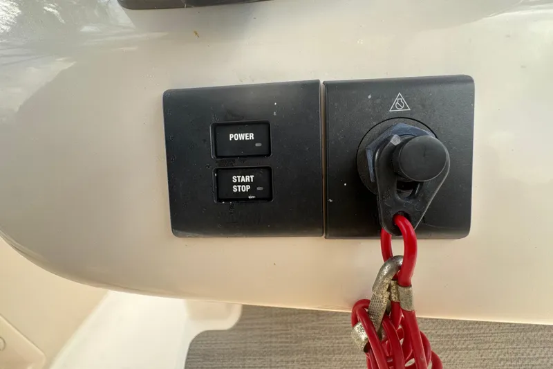 Slide: The Image of Control panel of 2021 Grady-White 251 Coastal Explorer with power and start/stop buttons. - 95