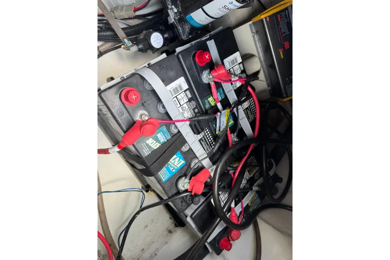 Slide: The Image of Battery compartment of 2021 Grady-White 251 Coastal Explorer with connected cables. - 88
