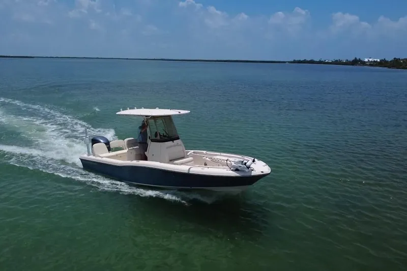Slide: The Image of 2021 Grady-White 251 Coastal Explorer boat cruising on clear blue water. - 40