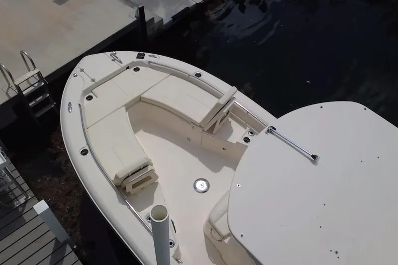 Slide: The Image of 2021 Grady-White 251 Coastal Explorer boat docked, featuring spacious seating and sleek design. - 16