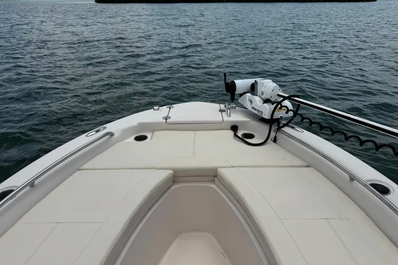 Slide: The Image of 2021 Grady-White 251 Coastal Explorer boat bow with seating and trolling motor on water. - 75