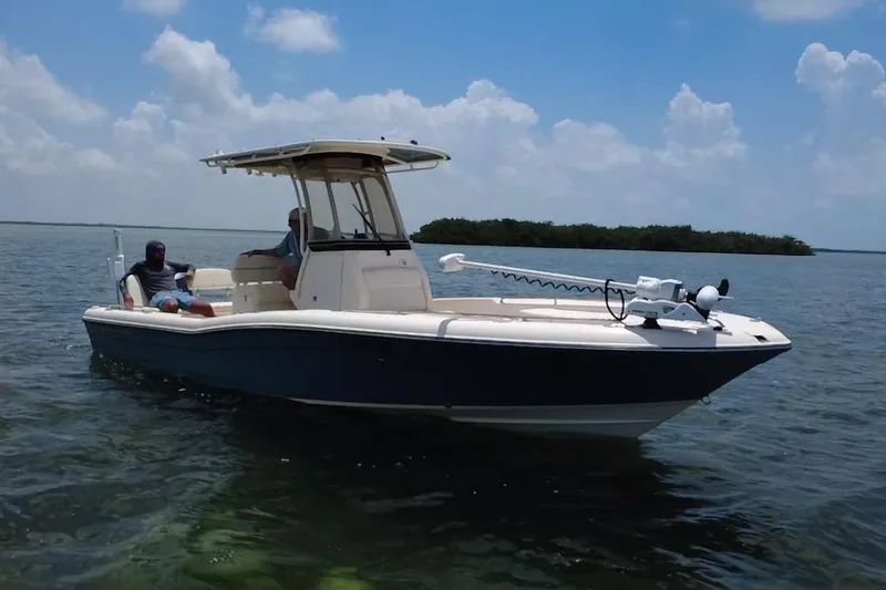 Slide: The Image of 2021 Grady-White 251 Coastal Explorer boat on calm water under a blue sky. - 24