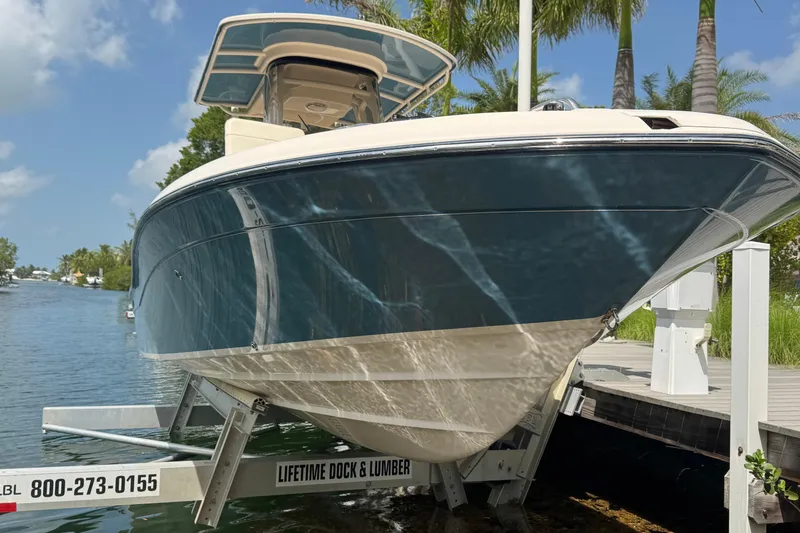 Slide: The Image of 2021 Grady-White 251 Coastal Explorer boat docked by a scenic waterfront. - 22