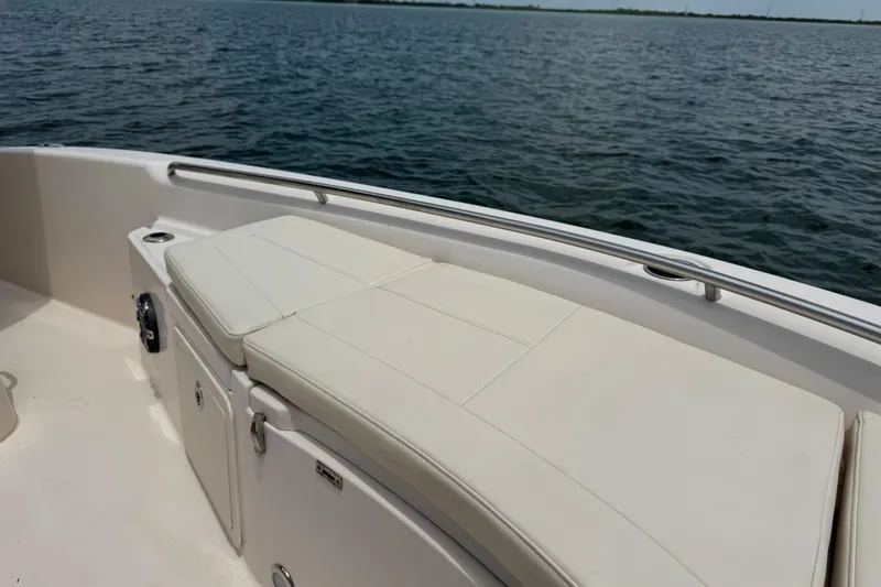 Slide: The Image of 2021 Grady-White 251 Coastal Explorer boat interior with cushioned seating by the water. - 73