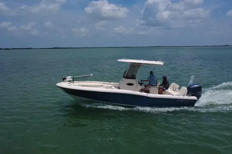 Slide: The Image of 2021 Grady-White 251 Coastal Explorer cruising on open water under a cloudy sky. - 35