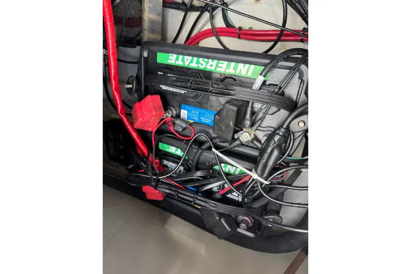 Slide: The Image of Battery compartment of 2021 Grady-White 251 Coastal Explorer with Interstate batteries and wiring. - 91