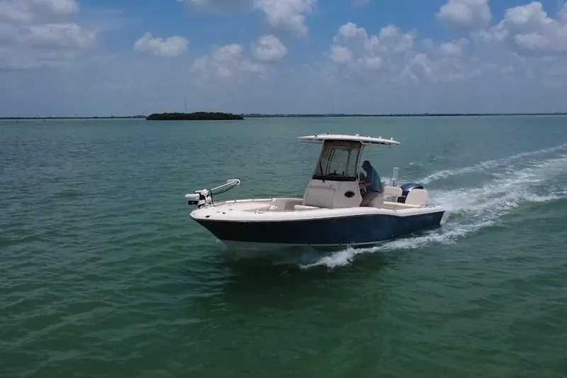 Slide: The Image of 2021 Grady-White 251 Coastal Explorer cruising on open water under a cloudy sky. - 34