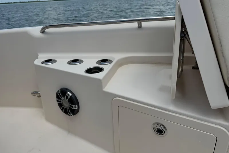 Slide: The Image of 2021 Grady-White 251 Coastal Explorer boat interior with cup holders and speaker. - 71
