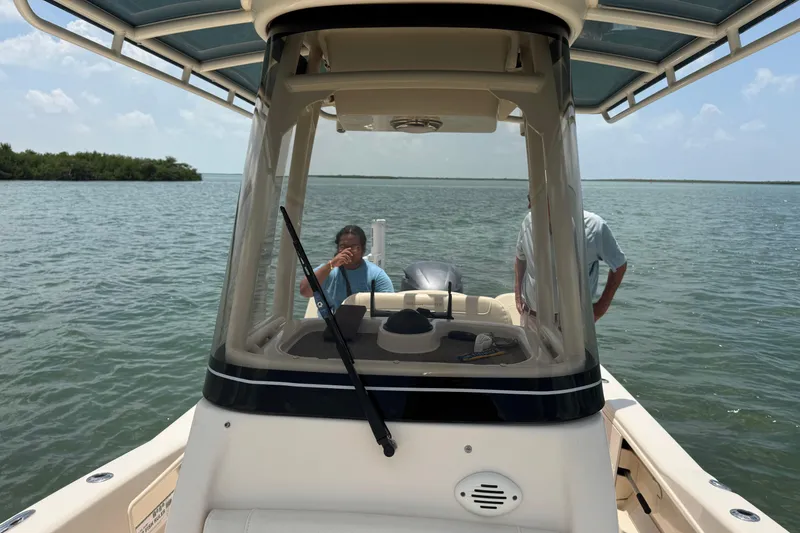 Slide: The Image of 2021 Grady-White 251 Coastal Explorer on calm waters, featuring two people onboard. - 82