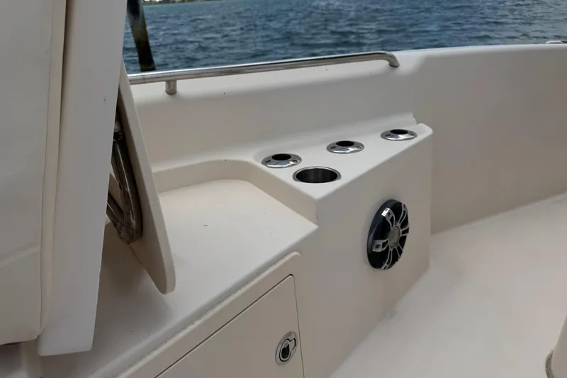 Slide: The Image of 2021 Grady-White 251 Coastal Explorer boat interior with cup holders and speaker. - 70