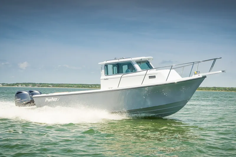 The Image of Manufacturer Provided Image: 2027 Parker 257 Explorer boat cruising on open water under clear skies. - 1