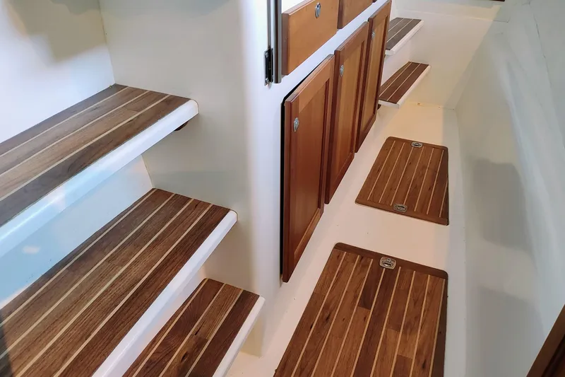 Slide: The Image of Wood-paneled stairs and cabinets in a boat, featuring elegant wood detailing. - 38