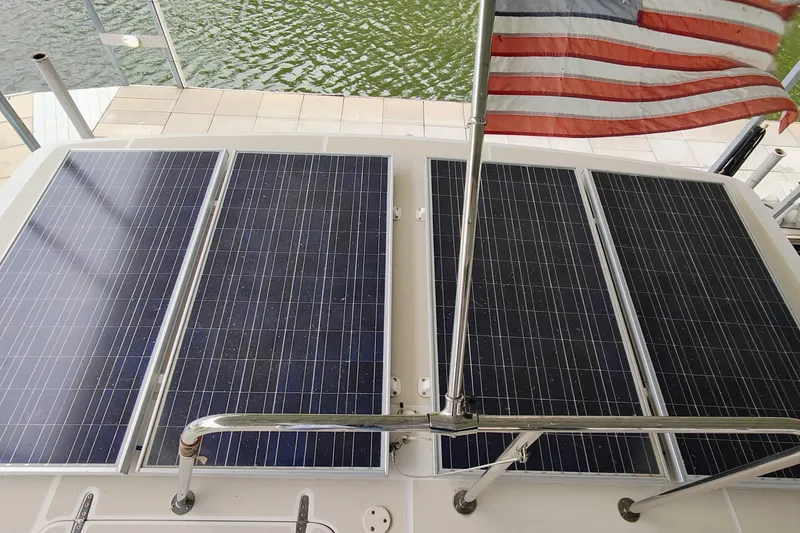 Slide: The Image of The image shows solar panels on a boat with an American flag in the background. - 22