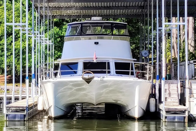 Slide: The Image of A 2009 Maine Cat P-47 catamaran docked in a covered boat slip. - 0