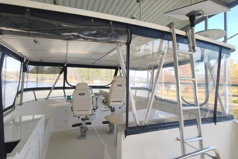Slide: The Image of Interior view of a 2009 Maine Cat P-47 with two white seats and clear windows. - 16