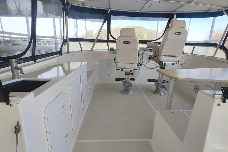 Slide: The Image of The image shows the cockpit of a 2009 Maine Cat P-47 with two white seats and a table. - 17