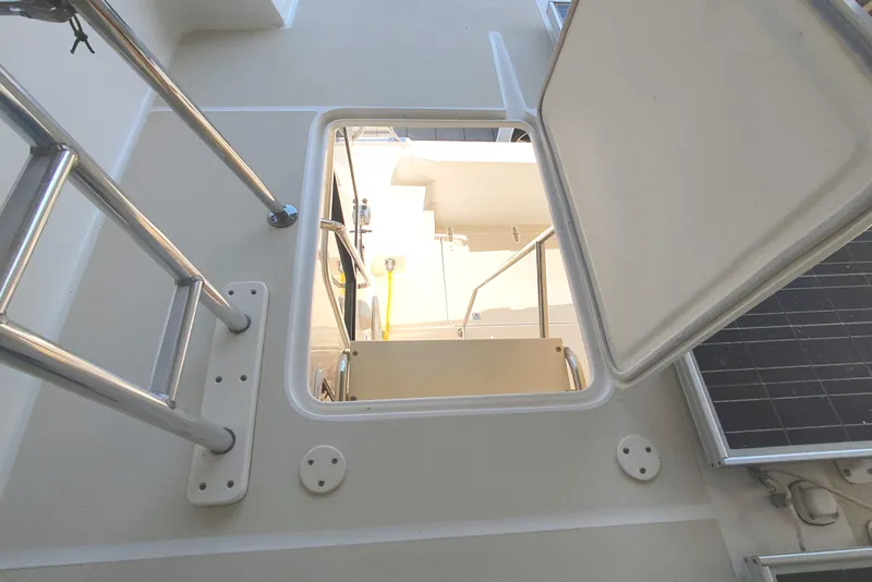 Slide: The Image of View through an open hatch on a boat with ladder and solar panel. - 23