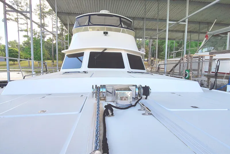 Slide: The Image of A 2009 Maine Cat P-47 in a covered dock. The deck and anchor winch are visible. - 11