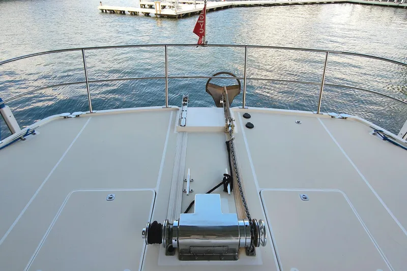 Slide: The Image of The image shows the deck of a 2009 Maine Cat P-47 overlooking the water. - 12
