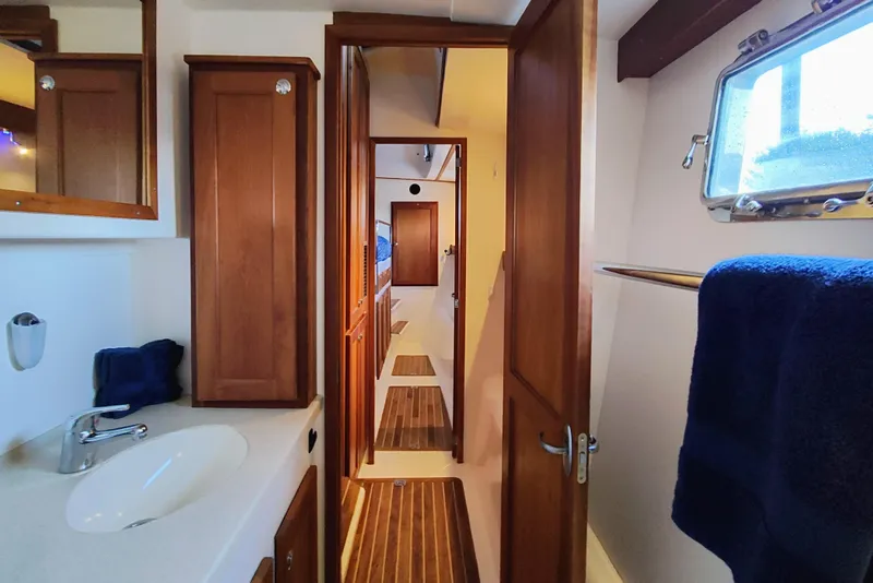 Slide: The Image of Interior of a 2009 Maine Cat P-47 with wood paneling and a sink. - 45