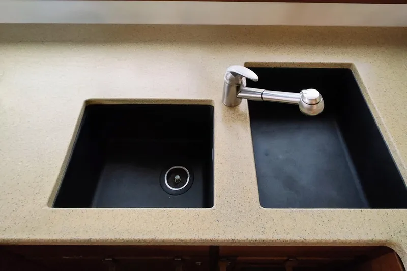 Slide: The Image of Double sink with modern faucet on a countertop. - 31