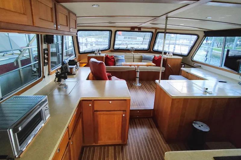Slide: The Image of Luxurious 2009 Maine Cat P-47 interior with spacious seating, wooden cabinetry, and large windows. - 26