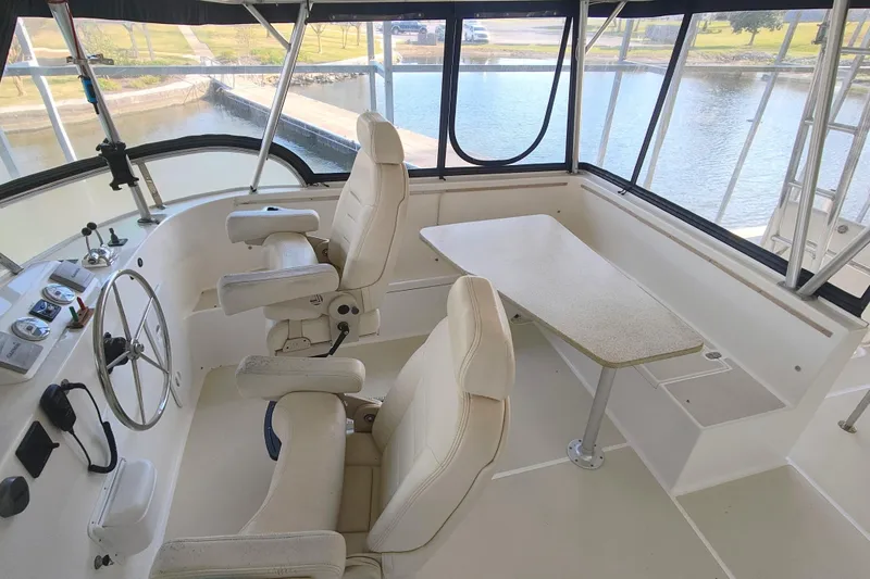 Slide: The Image of Interior of a 2009 Maine Cat P-47 with two white captain's chairs and a table. - 20