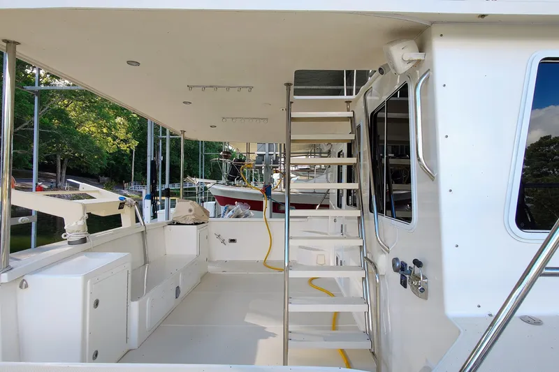 Slide: The Image of The image shows the deck of a 2009 Maine Cat P-47 with a staircase and seating area. - 15