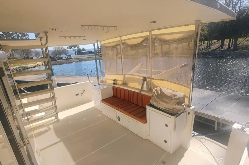 Slide: The Image of The image shows the deck of a 2009 Maine Cat P-47 with seating area and railing. - 5