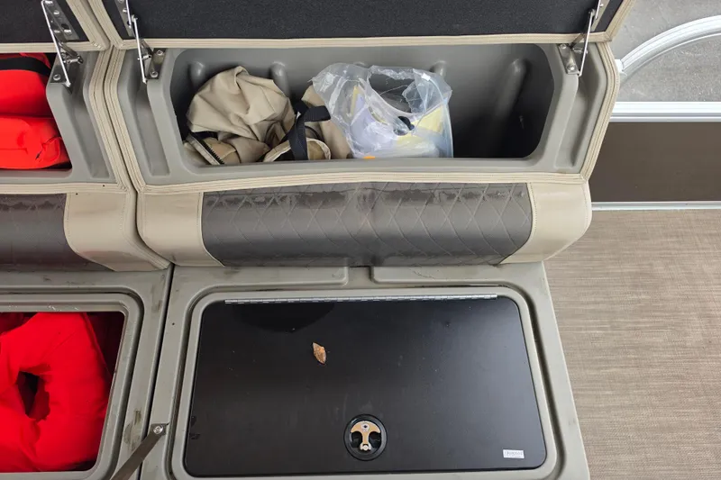Slide: The Image of Storage compartments on a 2023 Sun Tracker Bass Buggy 18 DLX boat, with life jackets and gear. - 50
