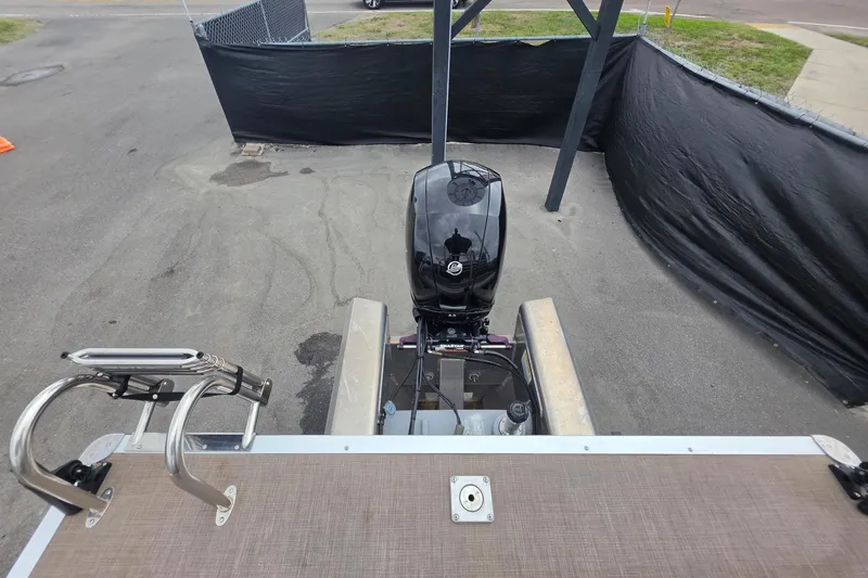 Slide: The Image of 2023 Sun Tracker Bass Buggy 18 DLX pontoon boat with outboard motor, rear view. - 58