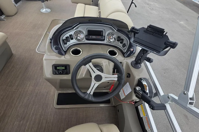 Slide: The Image of 2023 Sun Tracker Bass Buggy 18 DLX boat dashboard with steering wheel and controls. - 19