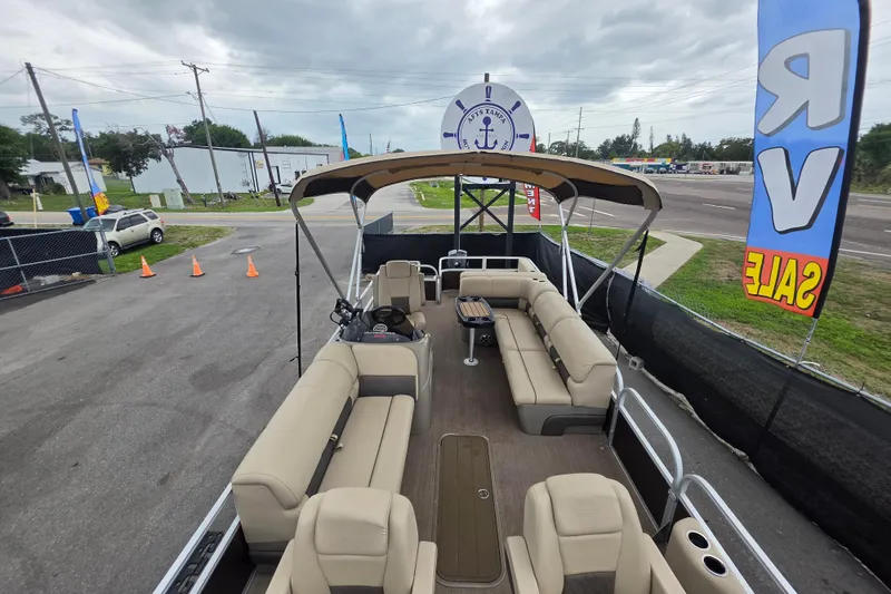 Slide: The Image of 2023 Sun Tracker Bass Buggy 18 DLX pontoon boat on display at a sales lot. - 35