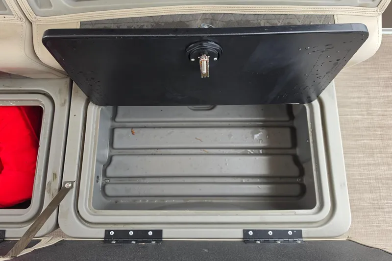 Slide: The Image of Storage compartment of 2023 Sun Tracker Bass Buggy 18 DLX boat, featuring a black lid. - 51