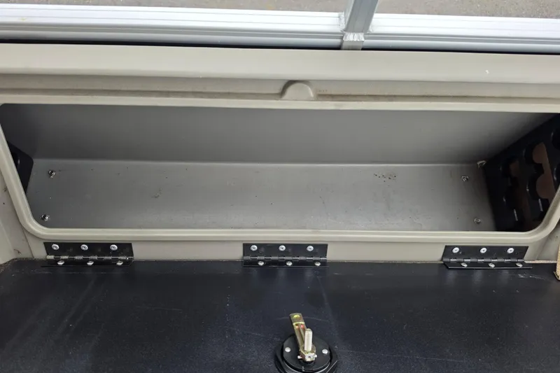 Slide: The Image of Storage compartment of 2023 Sun Tracker Bass Buggy 18 DLX boat, featuring durable hinges. - 55