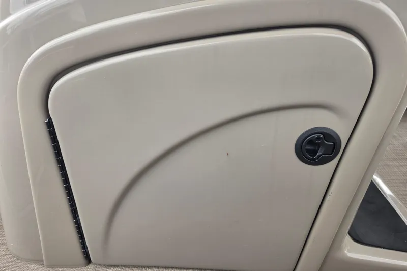 Slide: The Image of 2023 Sun Tracker Bass Buggy 18 DLX storage compartment with latch, beige finish. - 43