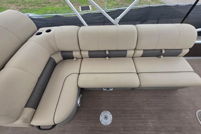 Slide: The Image of 2023 Sun Tracker Bass Buggy 18 DLX pontoon boat with beige seating and cup holders. - 17