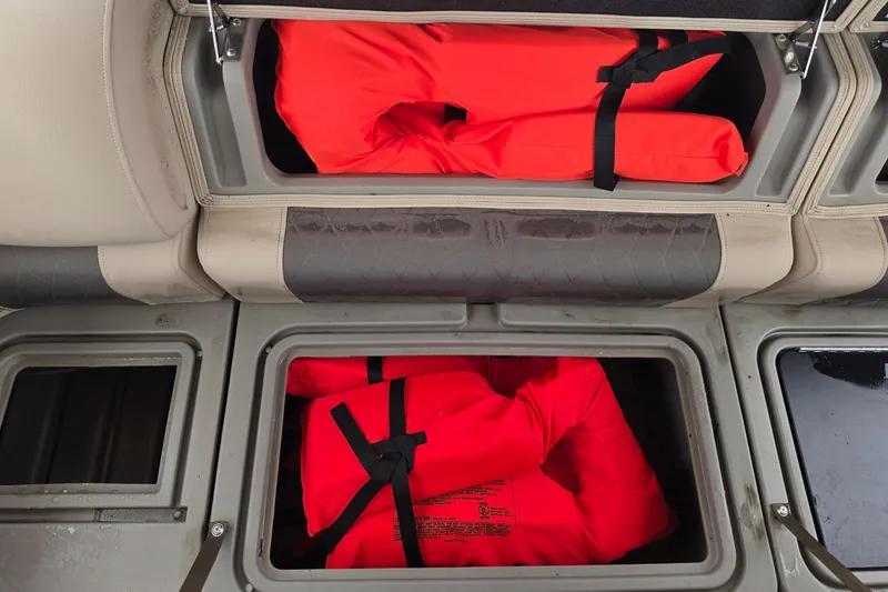 Slide: The Image of Storage compartments with life jackets on a 2023 Sun Tracker Bass Buggy 18 DLX boat. - 52
