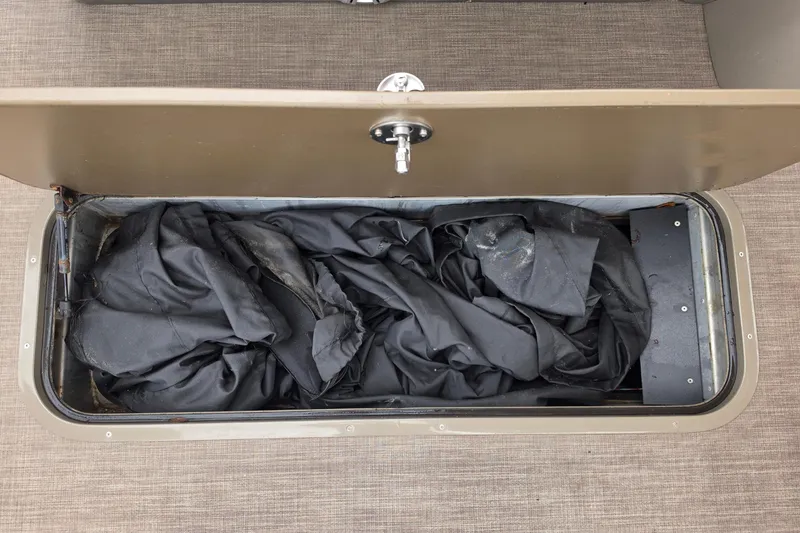 Slide: The Image of Storage compartment of 2023 Sun Tracker Bass Buggy 18 DLX with black cover inside. - 39