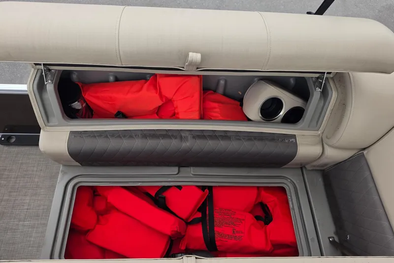 Slide: The Image of Storage compartments with life jackets on a 2023 Sun Tracker Bass Buggy 18 DLX boat. - 41