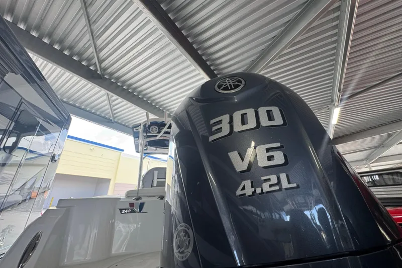 Slide: The Image of 2023 Wellcraft 242 Fisherman with Yamaha 300 V6 4.2L engine under a metal roof. - 7