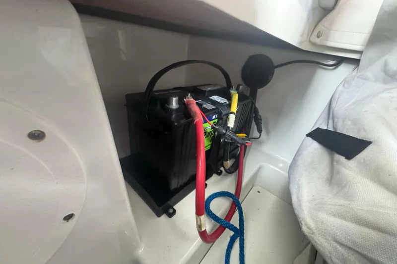 Slide: The Image of Battery compartment of 2023 Wellcraft 242 Fisherman boat with cables and storage. - 57