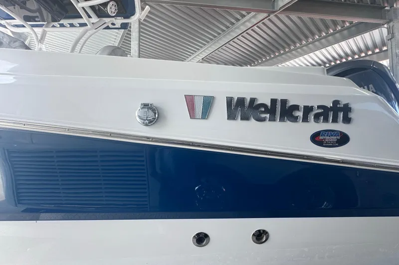 Slide: The Image of 2023 Wellcraft 242 Fisherman boat, featuring sleek design and branding details. - 5